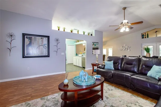a living room with furniture and a wooden floor