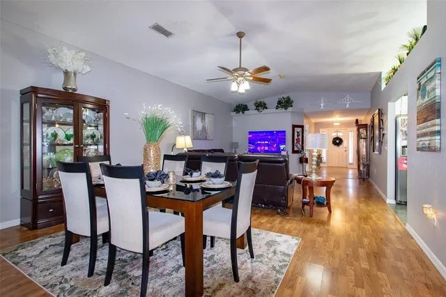a view of a dining room with furniture window and wooden floor