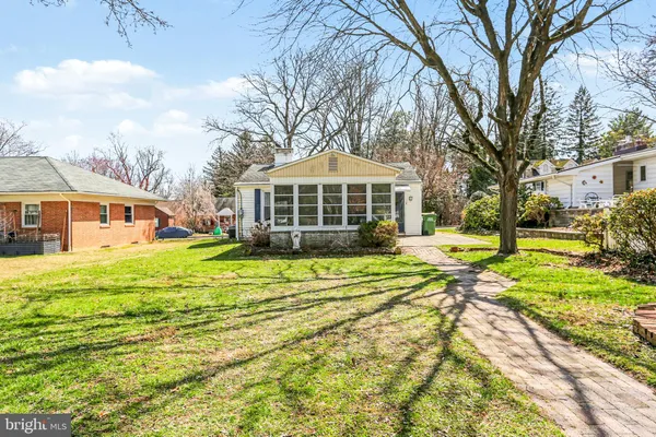 a view of a house with a yard patio and swimming pool