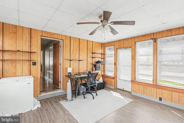 a workspace with wooden floor and windows