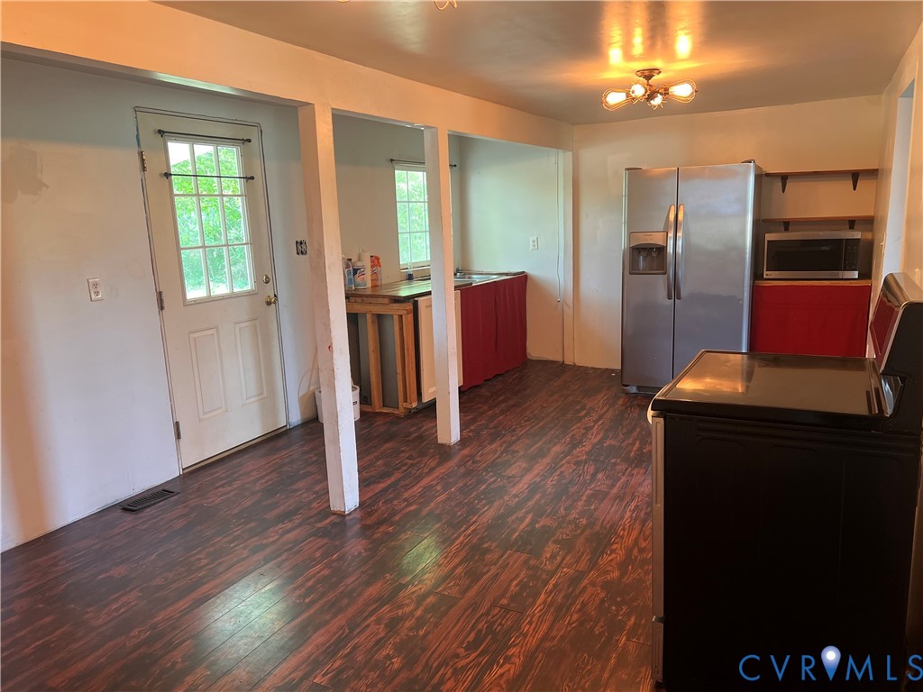 36210 Owens Grove Road Waverly, VA 23890 - Photo 10 of 24 a view of a kitchen with furniture a refrigerator and wooden floor