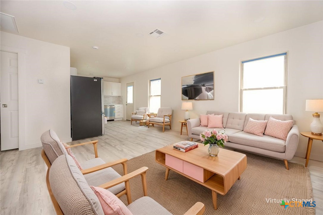 1010 South 4th Street Temple, TX 76504 - Photo 3 of 19 a living room with furniture and a flat screen tv