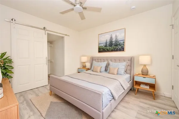 a bedroom with a bed and a potted plant