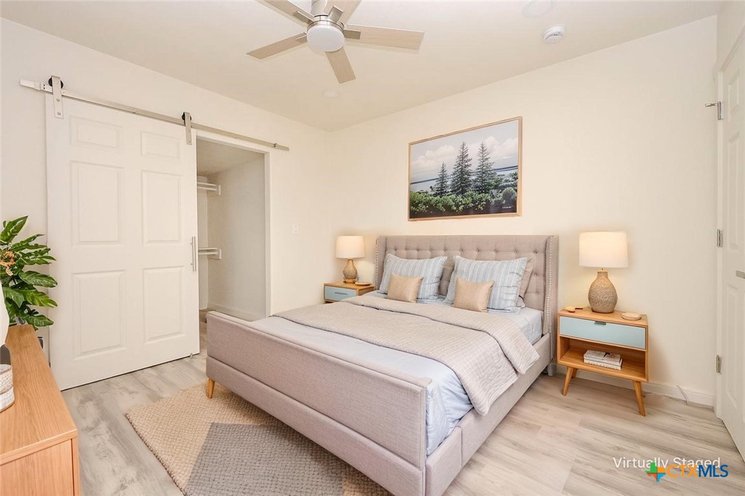 1010 South 4th Street Temple, TX 76504 - Photo 5 of 19 a bedroom with a bed and a potted plant