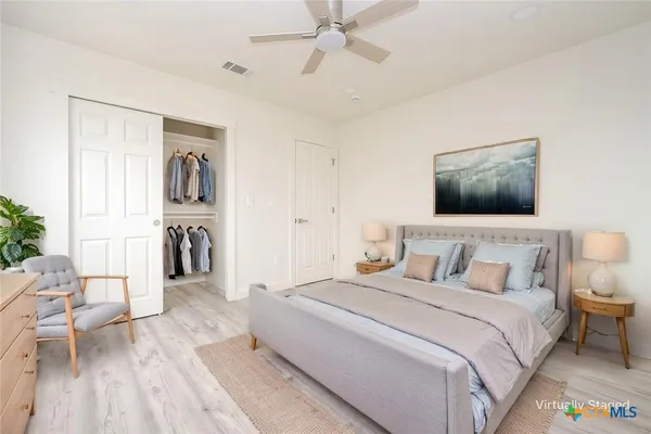 a bedroom with a bed and a couch