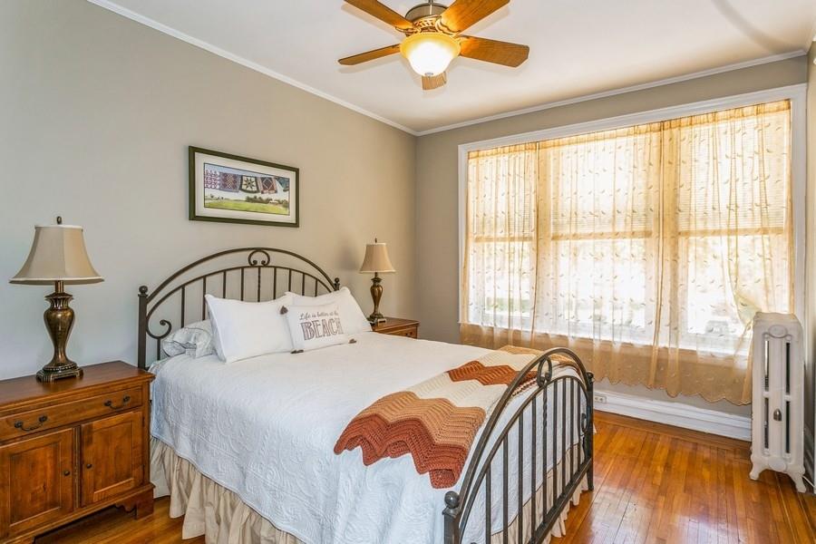 8917 Ridge Boulevard Brooklyn, NY 11209 - Photo 13 of 24 a bedroom with a bed and a large window with view of balcony