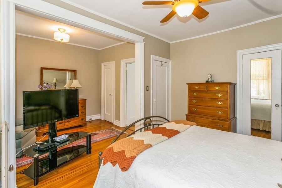 8917 Ridge Boulevard Brooklyn, NY 11209 - Photo 14 of 24 a bedroom with a bed and a flat tv screen on dresser