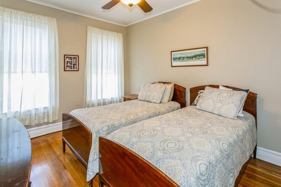 8917 Ridge Boulevard Brooklyn, NY 11209 - Photo 15 of 24 a bedroom with a bed and wooden floor