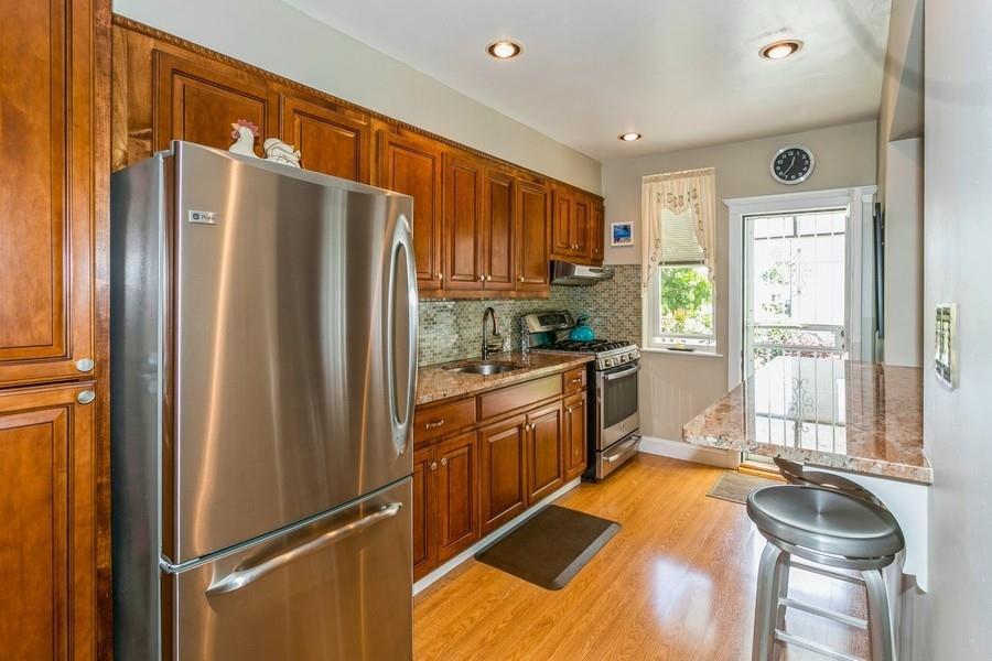 8917 Ridge Boulevard Brooklyn, NY 11209 - Photo 8 of 24 a kitchen with stainless steel appliances granite countertop a refrigerator a sink and a stove top oven