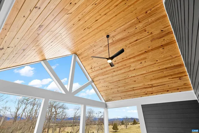 a large kitchen with a sink and wooden floor