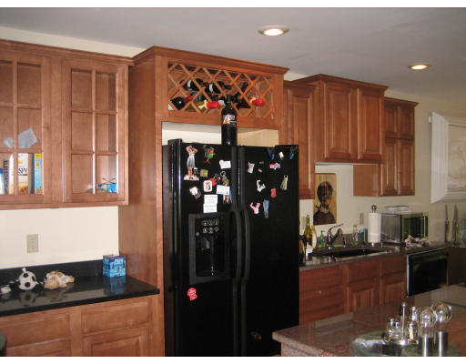 60 Tanglewood Road, Unit 60 Newton, MA 02459 - Photo 2 of 11 a kitchen with stainless steel appliances granite countertop a refrigerator and a stove top oven