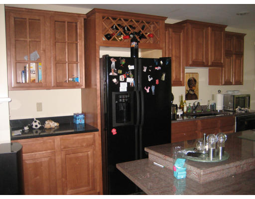 60 Tanglewood Road, Unit 60 Newton, MA 02459 - Photo 3 of 11 a kitchen with a refrigerator and a stove