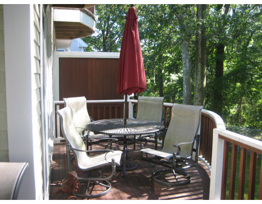 60 Tanglewood Road, Unit 60 Newton, MA 02459 - Photo 10 of 11 a view of balcony with two chairs and a table