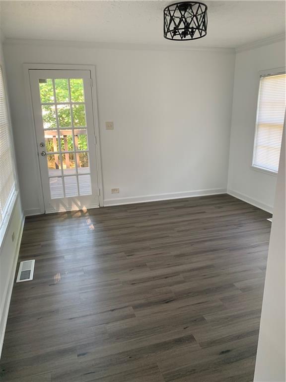 722 Level Creek Road Sugar Hill, GA 30518 - Photo 11 of 18 a view of an empty room with wooden floor and a window