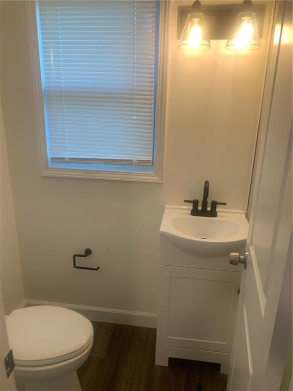 722 Level Creek Road Sugar Hill, GA 30518 - Photo 14 of 18 a bathroom with a toilet a sink and mirror