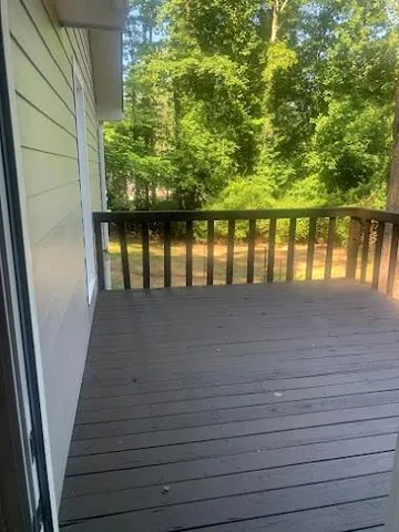 a view of a backyard with wooden fence