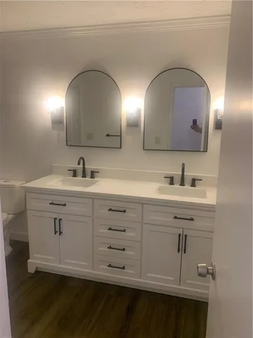 a bathroom with a double vanity sink and a mirror