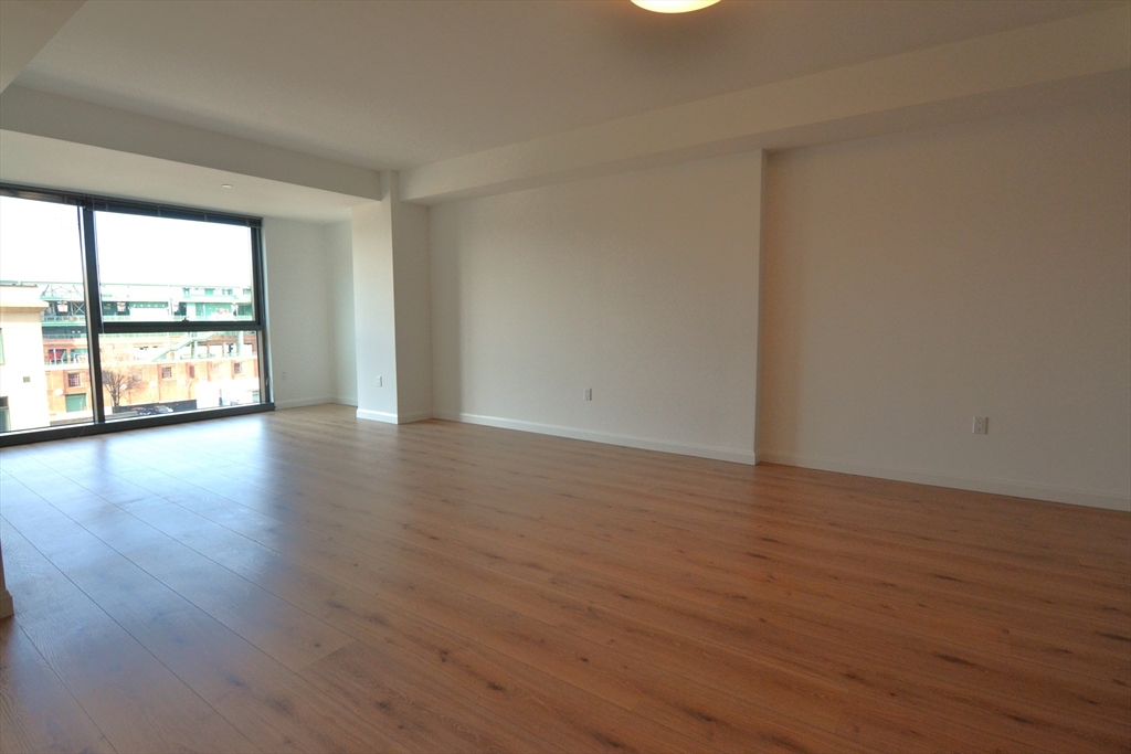 1282 Boylston Street, Unit 511 Boston, MA 02215 - Photo 12 of 18 a view of an empty room with wooden floor and a window