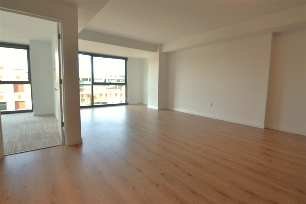 1282 Boylston Street, Unit 511 Boston, MA 02215 - Photo 13 of 18 a view of an empty room with wooden floor and a window