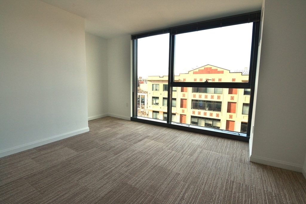 1282 Boylston Street, Unit 511 Boston, MA 02215 - Photo 16 of 18 an empty room with wooden floor and windows