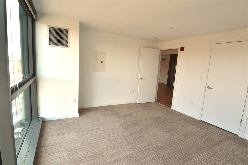 1282 Boylston Street, Unit 511 Boston, MA 02215 - Photo 18 of 18 a view of an empty room with wooden floor and a window