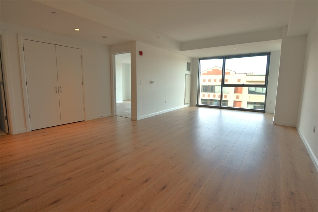 1282 Boylston Street, Unit 511 Boston, MA 02215 - Photo 9 of 18 a view of an empty room with wooden floor and a window
