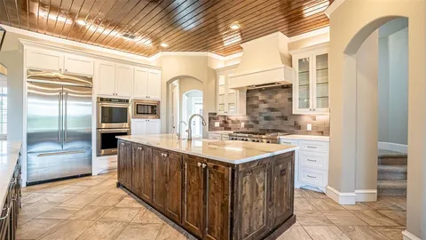 a kitchen with stainless steel appliances granite countertop a sink and cabinets