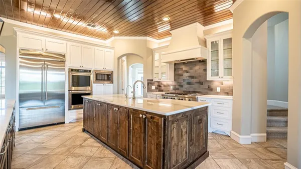 a kitchen with stainless steel appliances granite countertop a sink and cabinets