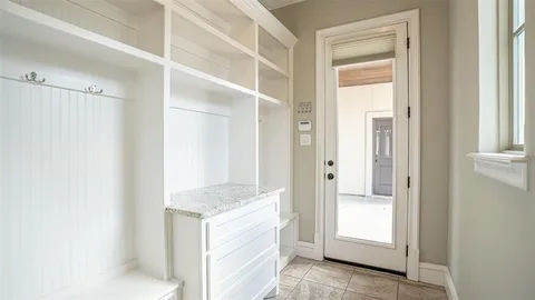 a view of an empty room with window and cabinet