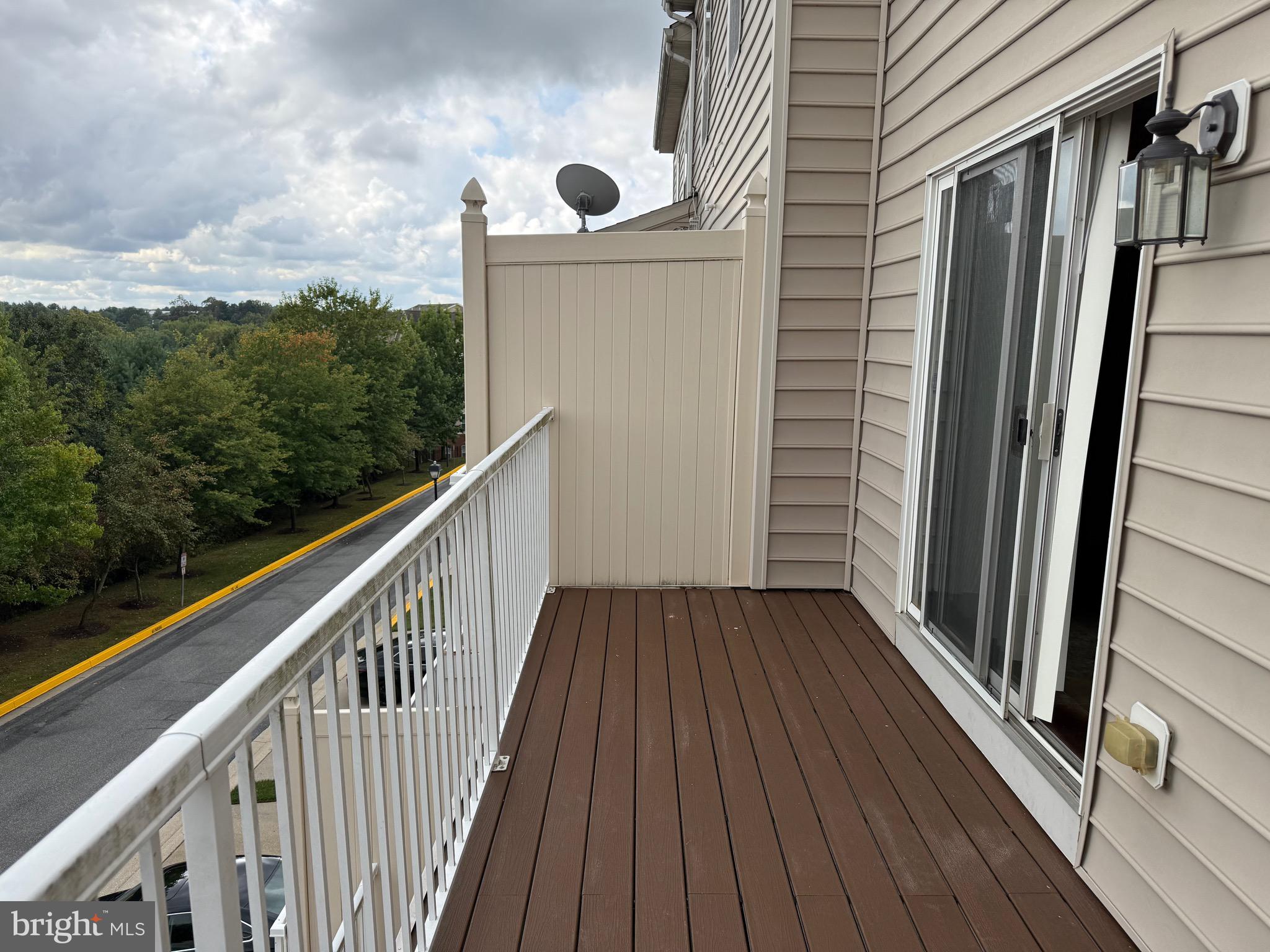 11039 Mill Centre Drive, Unit 11039 Owings Mills, MD 21117 - Photo 17 of 33 a view of balcony with wooden floor and fence