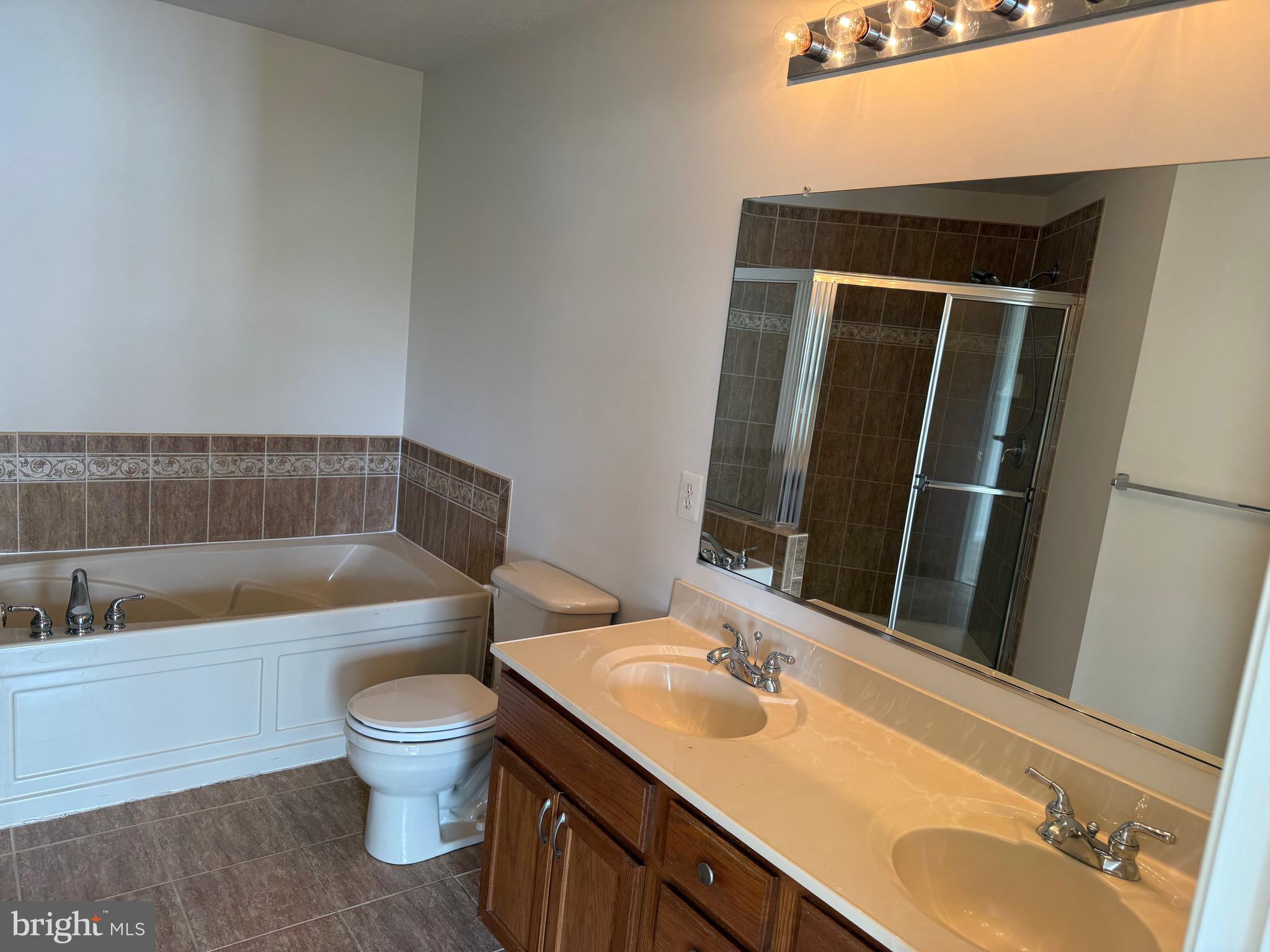 11039 Mill Centre Drive, Unit 11039 Owings Mills, MD 21117 - Photo 25 of 33 a bathroom with a sink and a mirror