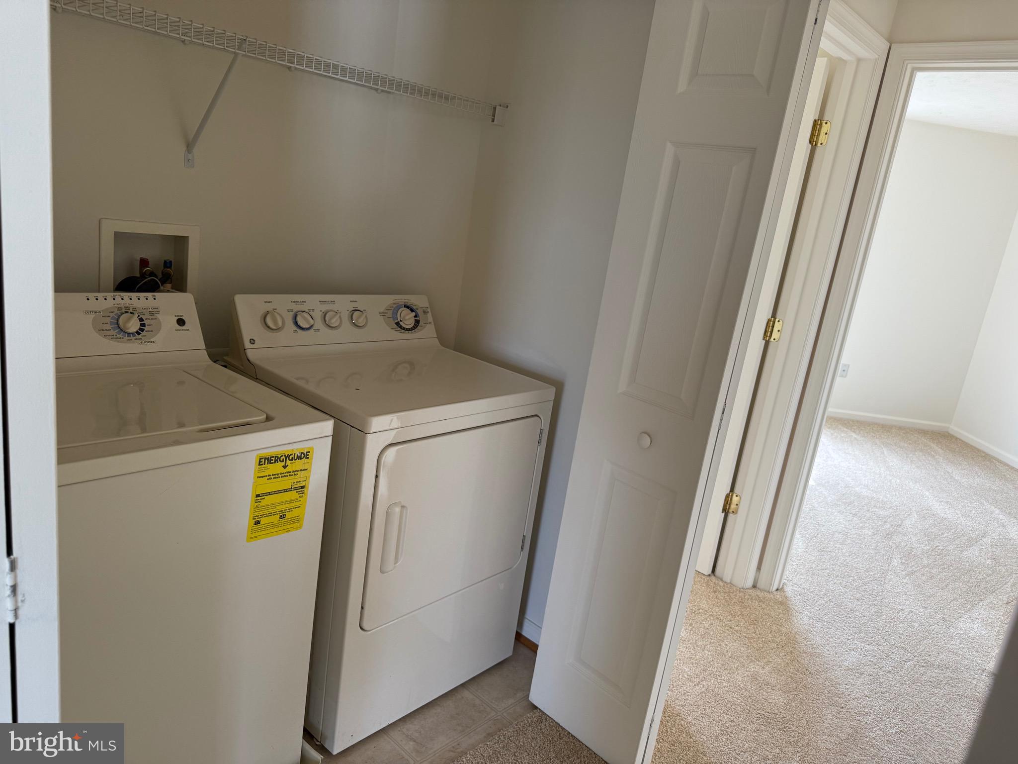11039 Mill Centre Drive, Unit 11039 Owings Mills, MD 21117 - Photo 30 of 33 a utility room with dryer and washer