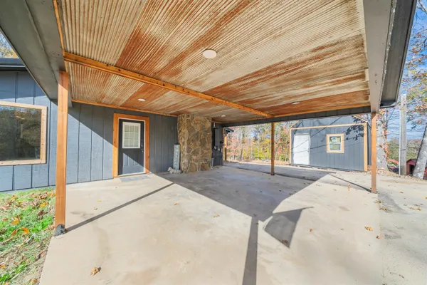 a kitchen with stainless steel appliances granite countertop a refrigerator a sink dishwasher a stove with white cabinets and wooden floor