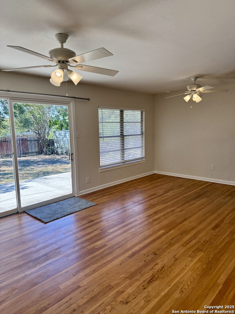 410 Shannon Lee Street San Antonio, TX 78216 - Photo 11 of 19 a view of an empty room with wooden floor and a window