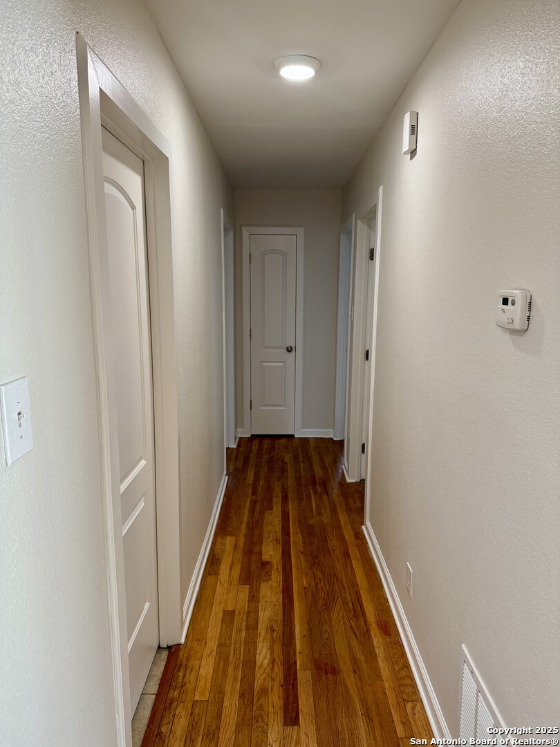 410 Shannon Lee Street San Antonio, TX 78216 - Photo 12 of 19 a view of a hallway with wooden floor
