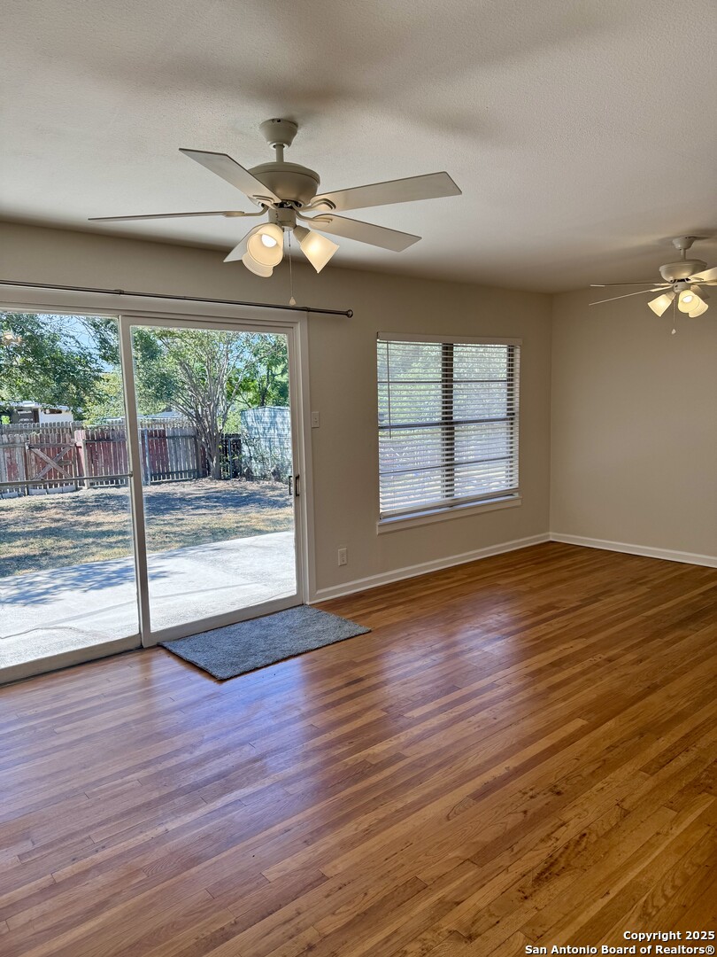 410 Shannon Lee Street San Antonio, TX 78216 - Photo 13 of 19 an empty room with wooden floor fan and windows