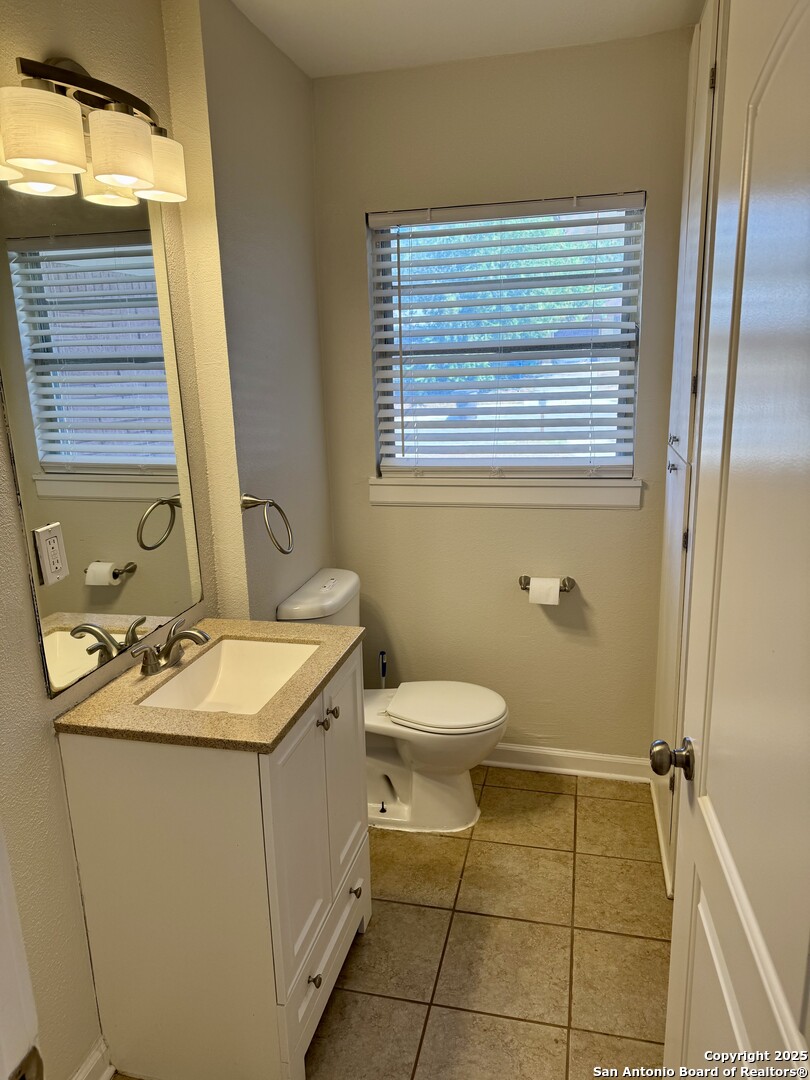 410 Shannon Lee Street San Antonio, TX 78216 - Photo 14 of 19 a bathroom with a sink toilet and window
