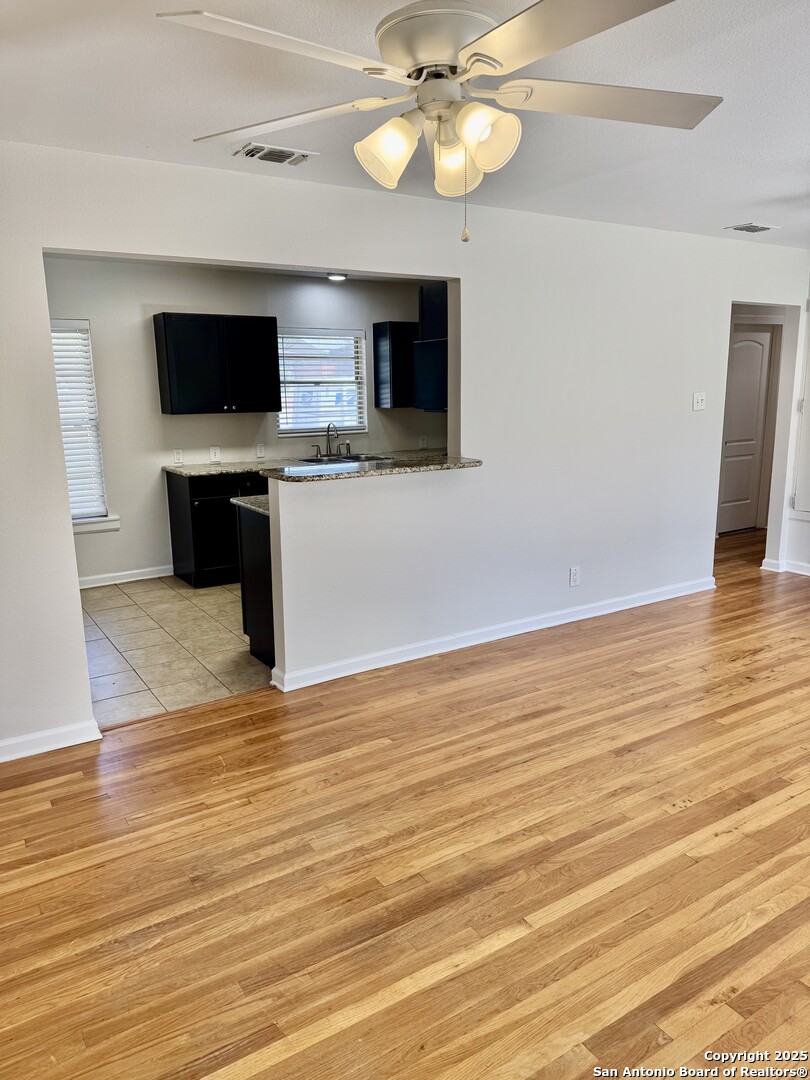 410 Shannon Lee Street San Antonio, TX 78216 - Photo 8 of 19 a view of a room with wooden floor and a flat screen tv