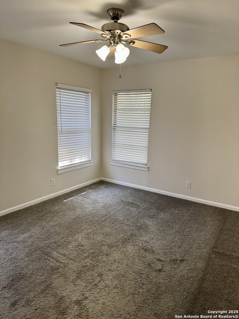 410 Shannon Lee Street San Antonio, TX 78216 - Photo 9 of 19 an empty room with windows and fan