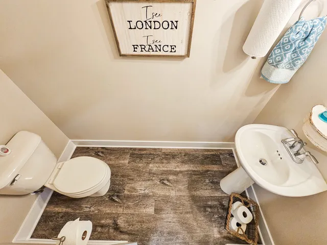 a bathroom with a toilet a sink and a mirror