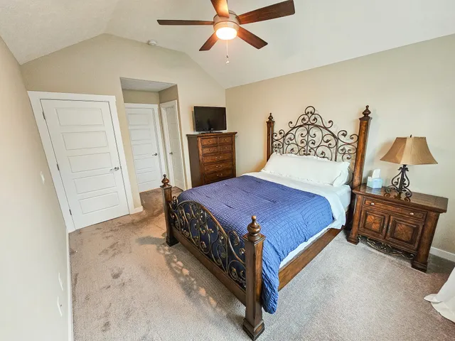 a bedroom with a bed and a chandelier