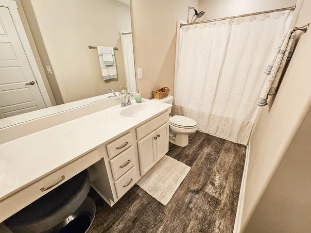 a spacious bathroom with a sink and a mirror
