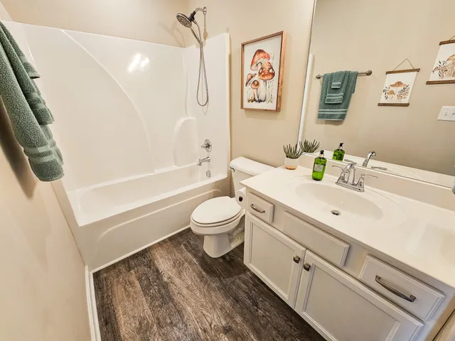 a bathroom with a white toilet sitting next to a bathroom sink and a tub