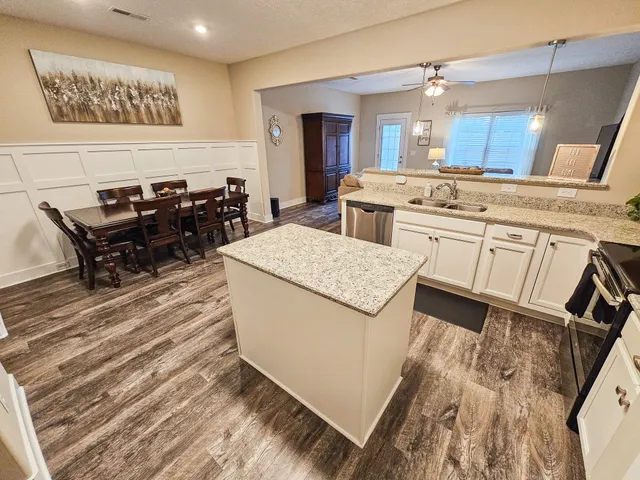a kitchen with a sink appliances and cabinets