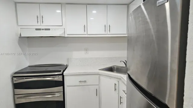 a kitchen with appliances and cabinets
