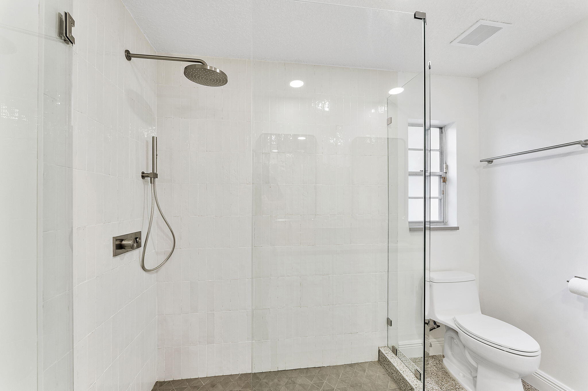 9180 Pine Springs Drive Boca Raton, FL 33428 - Photo 17 of 29 a bathroom with a shower and toilet
