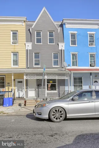 a front view of a house with a parking space