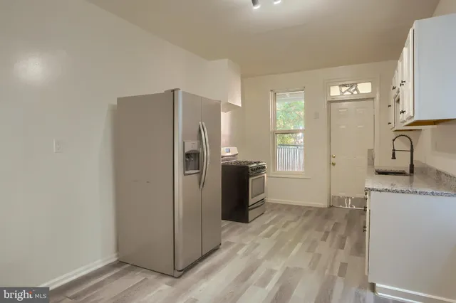 a kitchen with a refrigerator and a sink