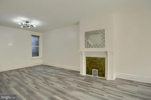 a view of an empty room with a fireplace