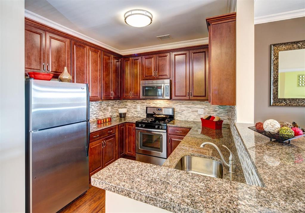 125 West Main Street, Unit 321 Somerville, NJ 08876 - Photo 13 of 17 a kitchen with stainless steel appliances granite countertop a sink stove and refrigerator